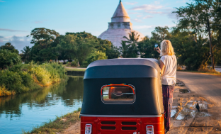 A tuk-tuk beside a Sri Lankan temple