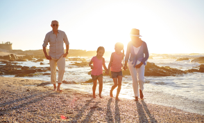 A multi-generational family at sunset